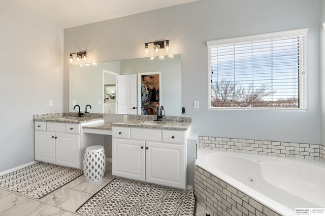 4706 S 187th Ave, Omaha, NE 68135 - full bathroom featuring vanity, a whirlpool tub, and a spacious closet