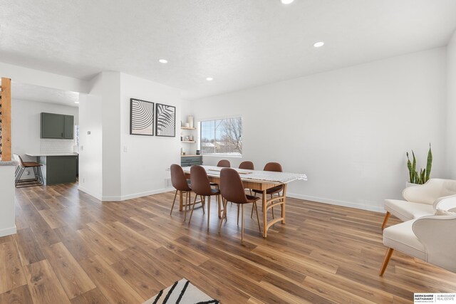 4706 S 187th Ave, Omaha, NE 68135 - dining room featuring wood finished floors, recessed lighting, and baseboards
