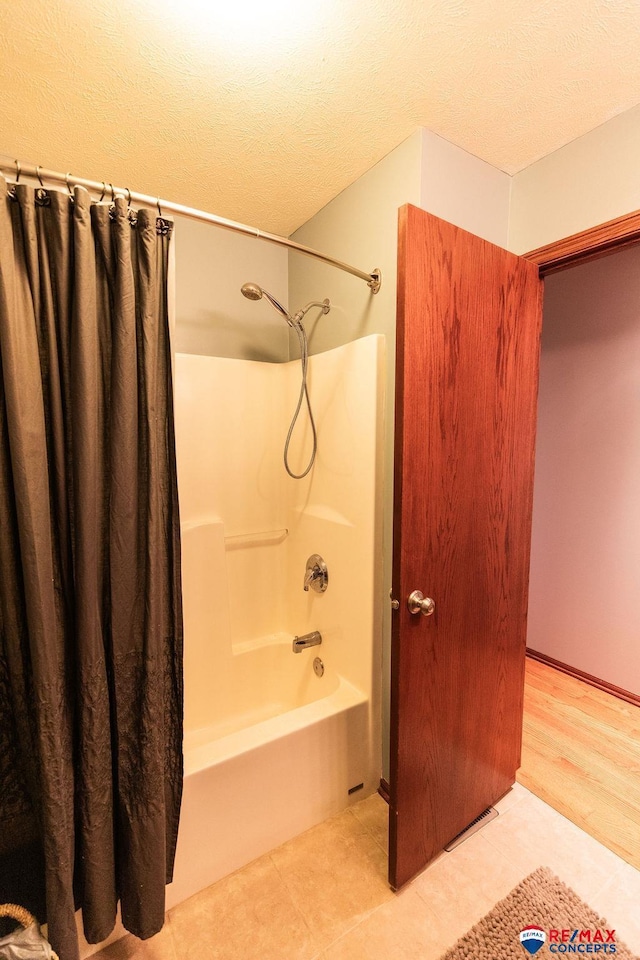 29300 S Golden Pond Rd, Firth, NE 68358 - bathroom with shower / tub combo and a textured ceiling
