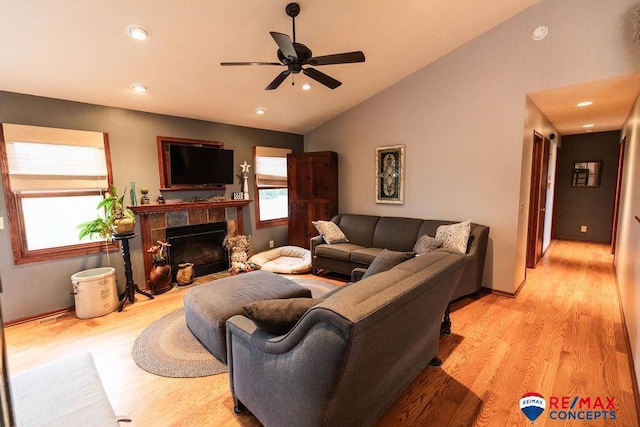 29300 S Golden Pond Rd, Firth, NE 68358 - living room with a ceiling fan, light wood-type flooring, lofted ceiling, a tile fireplace, and recessed lighting