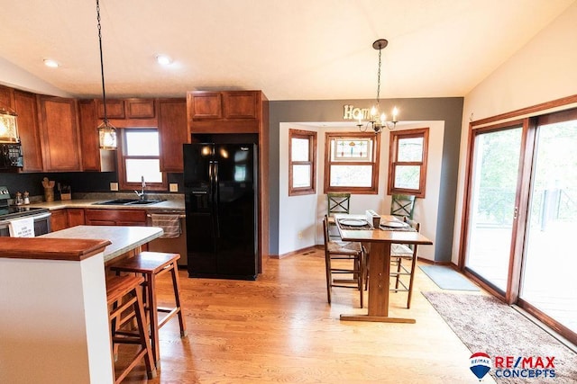 29300 S Golden Pond Rd, Firth, NE 68358 - kitchen with black appliances, a sink, vaulted ceiling, light wood finished floors, and pendant lighting