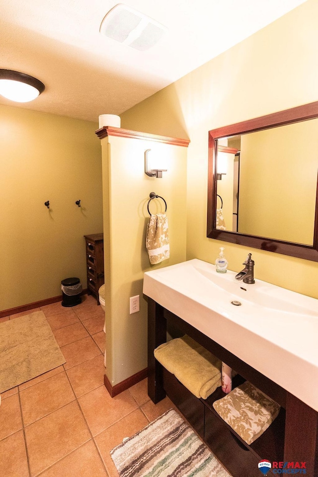 29300 S Golden Pond Rd, Firth, NE 68358 - bathroom featuring tile patterned flooring, baseboards, vanity, and toilet