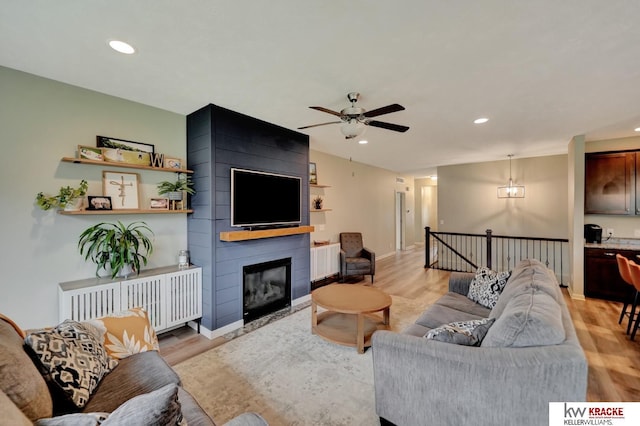 7237 Yankee Woods Dr, Lincoln, NE 68516 - living area featuring light wood-style flooring, ceiling fan, recessed lighting, baseboards, and a fireplace