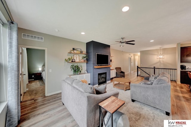 7237 Yankee Woods Dr, Lincoln, NE 68516 - living room featuring light wood-style floors, ceiling fan, recessed lighting, a large fireplace, and baseboards