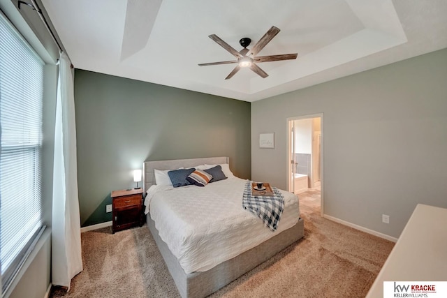 7237 Yankee Woods Dr, Lincoln, NE 68516 - bedroom featuring carpet floors, multiple windows, baseboards, and a tray ceiling