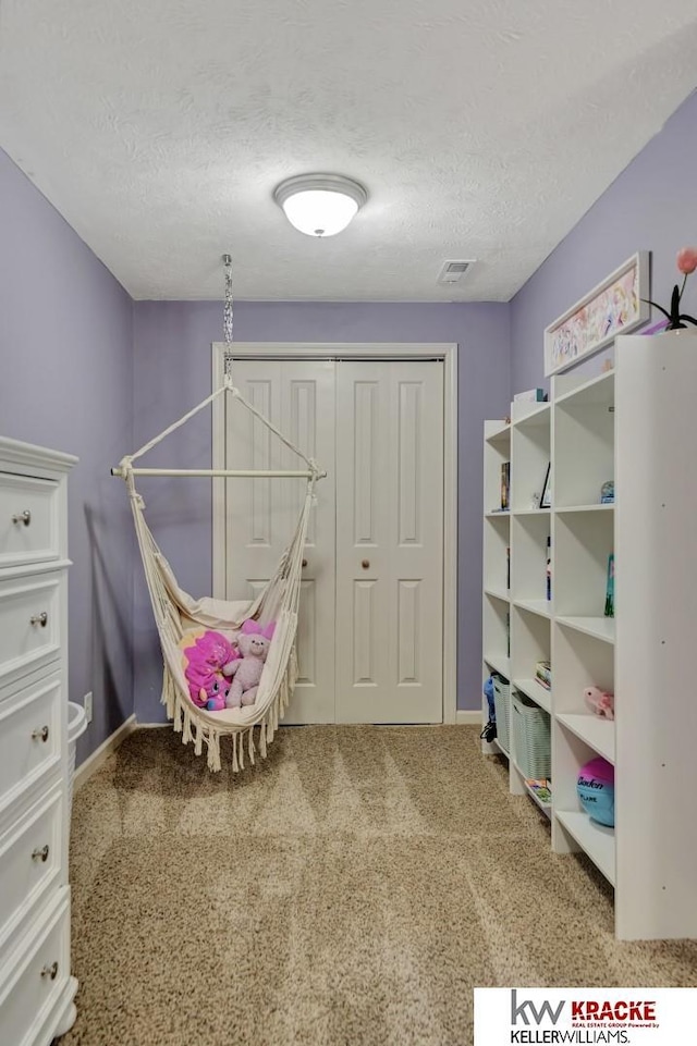 7237 Yankee Woods Dr, Lincoln, NE 68516 - recreation room with baseboards, carpet floors, and a textured ceiling