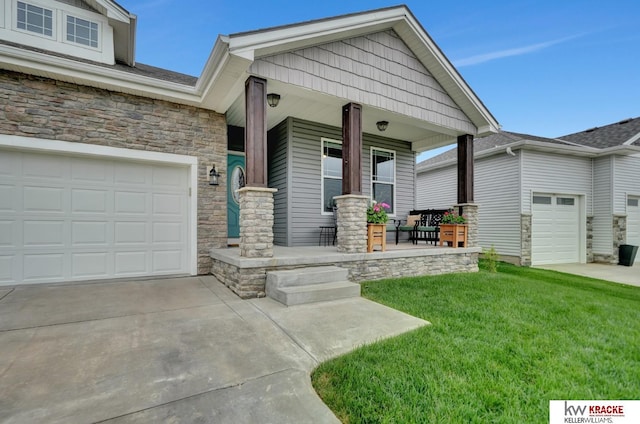 7237 Yankee Woods Dr, Lincoln, NE 68516 - view of front of home featuring covered porch, stone siding, concrete driveway, and a front lawn