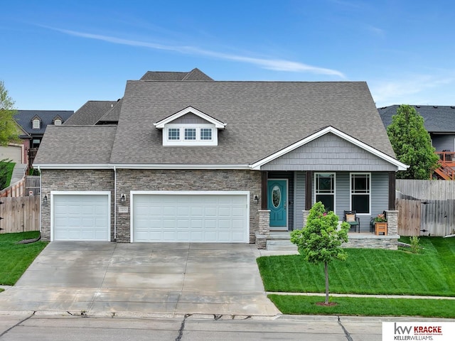 7237 Yankee Woods Dr, Lincoln, NE 68516 - view of front of home featuring stone siding, concrete driveway, a porch, a garage, and a shingled roof