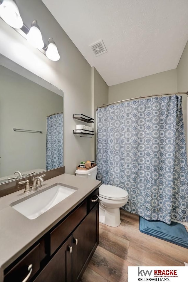 7237 Yankee Woods Dr, Lincoln, NE 68516 - full bathroom with wood finished floors, vanity, and toilet