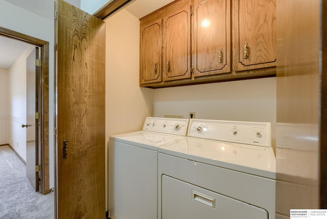 1115 Arbor Ridge Dr, Council Bluffs, IA 51503 - laundry area with washer and dryer, light colored carpet, and cabinet space