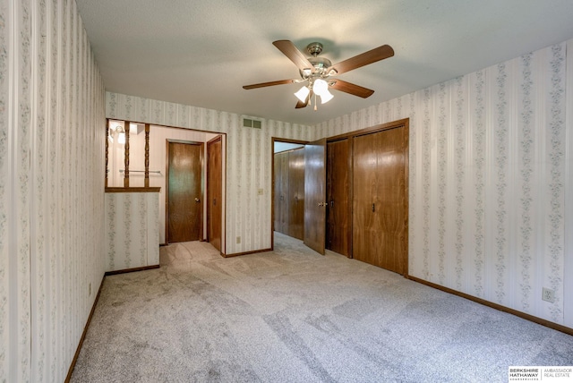 1115 Arbor Ridge Dr, Council Bluffs, IA 51503 - unfurnished bedroom with carpet flooring, ceiling fan, and wallpapered walls