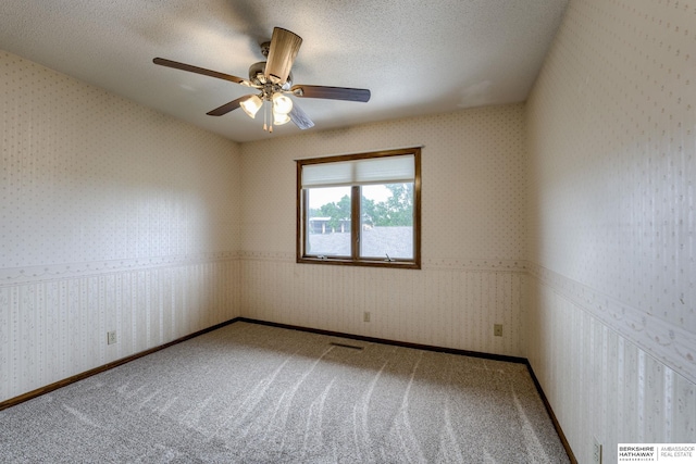 1115 Arbor Ridge Dr, Council Bluffs, IA 51503 - carpeted empty room with wallpapered walls, ceiling fan, and a textured ceiling