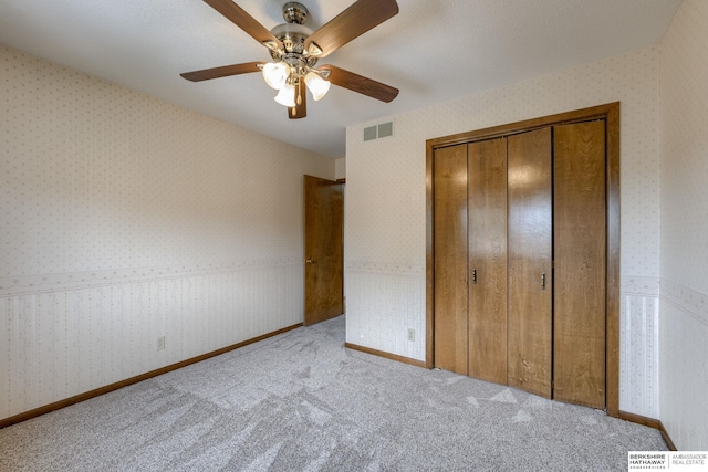 1115 Arbor Ridge Dr, Council Bluffs, IA 51503 - unfurnished bedroom featuring carpet, a closet, wallpapered walls, and ceiling fan