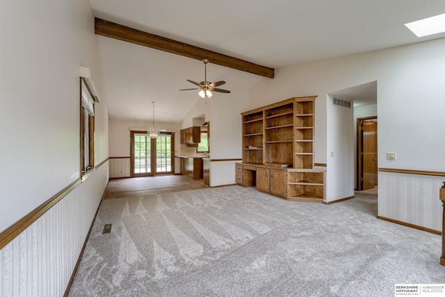 1115 Arbor Ridge Dr, Council Bluffs, IA 51503 - unfurnished living room with light colored carpet, a ceiling fan, a skylight, french doors, and baseboards
