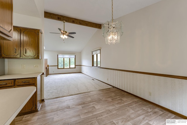 1115 Arbor Ridge Dr, Council Bluffs, IA 51503 - unfurnished dining area featuring ceiling fan, light wood-style floors, a wainscoted wall, and a chandelier
