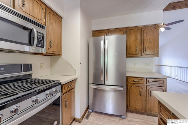 1115 Arbor Ridge Dr, Council Bluffs, IA 51503 - kitchen featuring appliances with stainless steel finishes, brown cabinetry, and light countertops