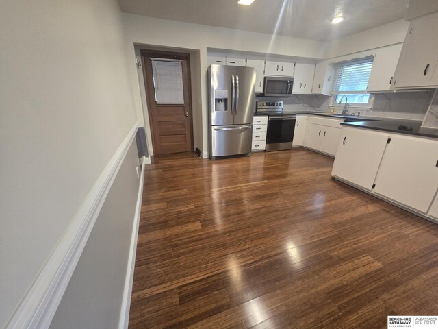 713 Janes View St, Papillion, NE 68046 - kitchen with stainless steel appliances, dark wood-style floors, white cabinetry, and dark countertops