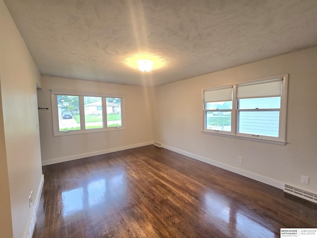 713 Janes View St, Papillion, NE 68046 - unfurnished room featuring plenty of natural light, dark wood-style floors, a textured ceiling, and baseboards