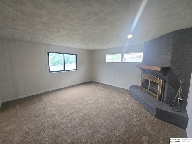 713 Janes View St, Papillion, NE 68046 - unfurnished living room with carpet flooring, a fireplace, and a textured ceiling