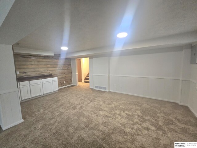 713 Janes View St, Papillion, NE 68046 - finished below grade area featuring carpet flooring, wood walls, stairway, and recessed lighting