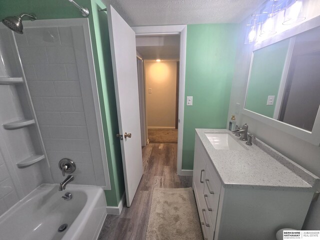 713 Janes View St, Papillion, NE 68046 - full bathroom featuring wood finished floors, vanity, washtub / shower combination, a textured ceiling, and baseboards