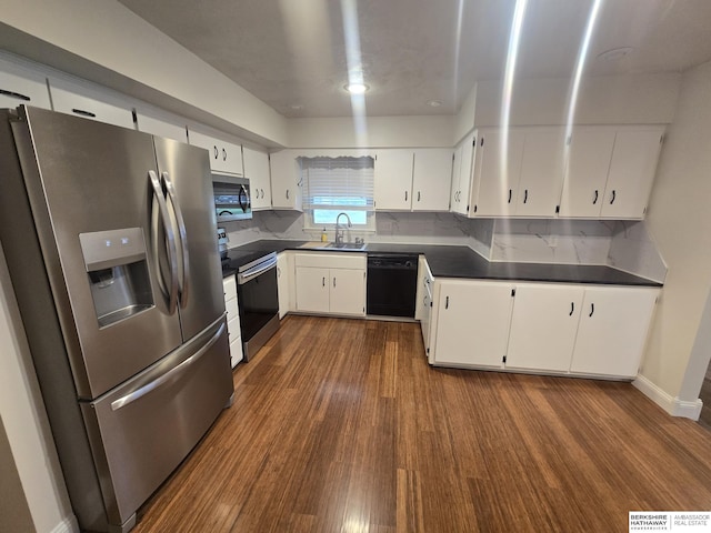 713 Janes View St, Papillion, NE 68046 - kitchen with stainless steel appliances, dark countertops, dark wood-style flooring, white cabinetry, and a sink