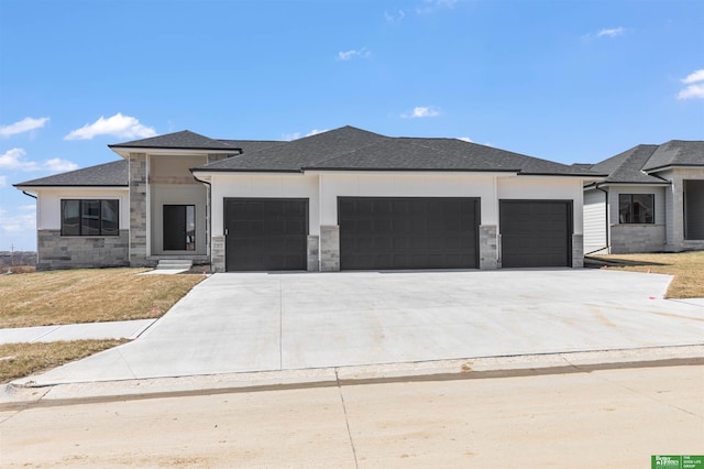 5408 N 196th Ave, Elkhorn, NE 68022 - view of front of property with an attached garage, concrete driveway, stone siding, and roof with shingles