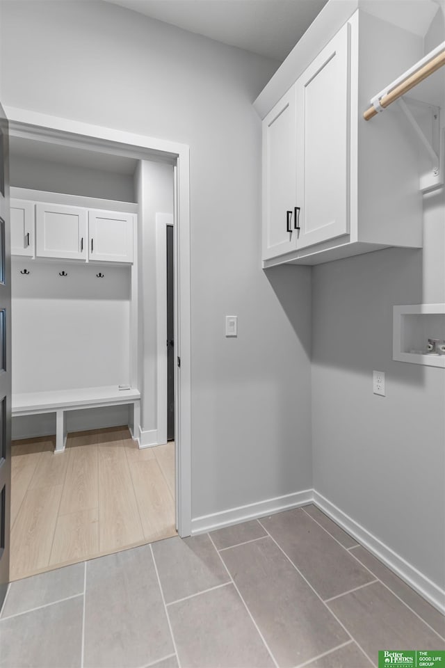 5408 N 196th Ave, Elkhorn, NE 68022 - washroom with cabinet space, baseboards, tile patterned flooring, and washer hookup