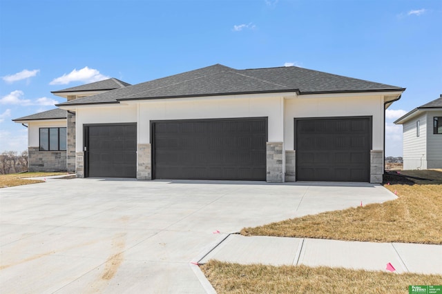 5408 N 196th Ave, Elkhorn, NE 68022 - view of property exterior with an attached garage, concrete driveway, stone siding, and a shingled roof