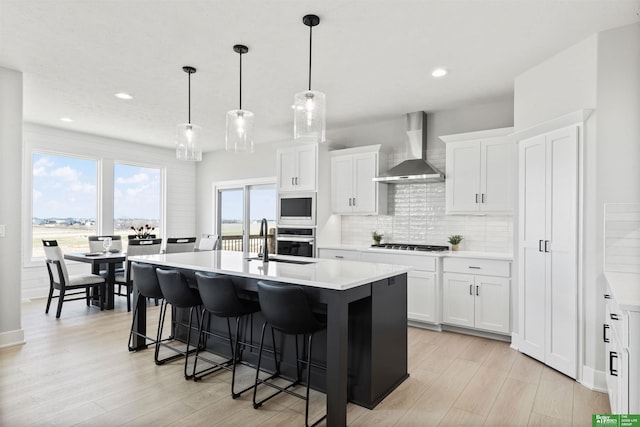 5408 N 196th Ave, Elkhorn, NE 68022 - kitchen featuring wall chimney range hood, a sink, oven, cooktop, and light countertops