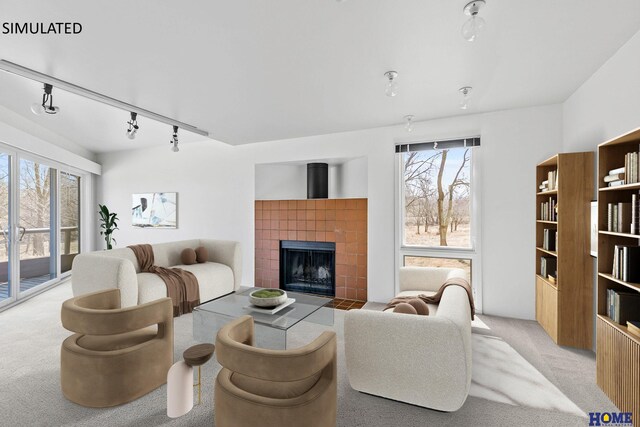 4144 S 88th St, Lincoln, NE 68520 - living area with light colored carpet, track lighting, and a tiled fireplace