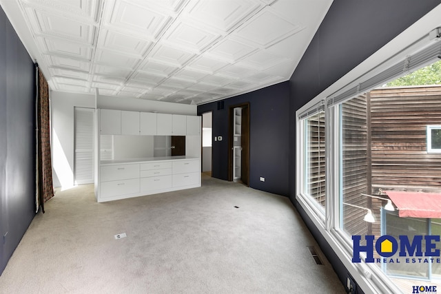 4144 S 88th St, Lincoln, NE 68520 - unfurnished living room featuring light colored carpet and an ornate ceiling