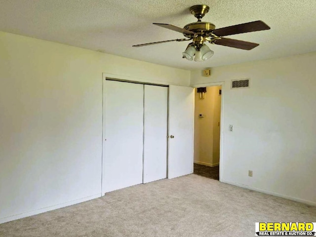 64070 67th Hwy, Peru, NE 68421 - unfurnished bedroom with carpet, a textured ceiling, a closet, and ceiling fan