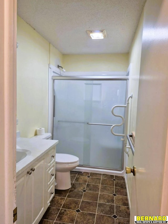 64070 67th Hwy, Peru, NE 68421 - full bath featuring vanity, toilet, a shower stall, a textured ceiling, and tile patterned flooring