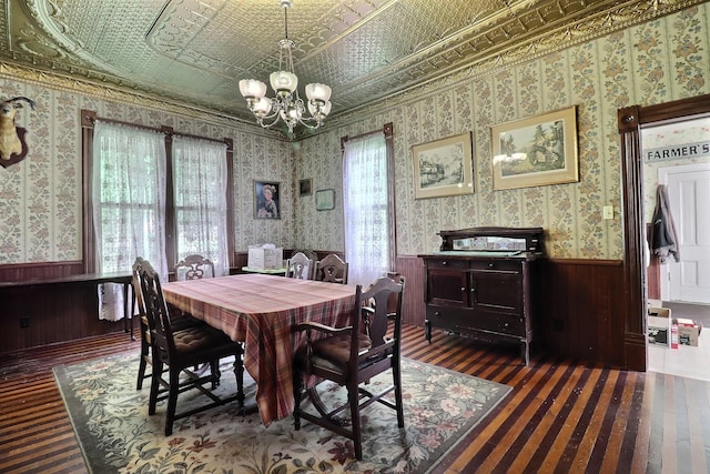 450 W 6th St, Fremont, NE 68025 - dining space featuring dark wood-style floors, a chandelier, an ornate ceiling, a wainscoted wall, and wooden walls