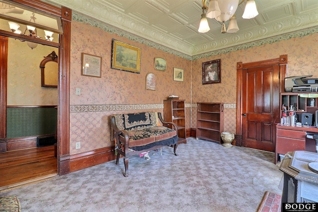 450 W 6th St, Fremont, NE 68025 - living area featuring wallpapered walls, a wainscoted wall, carpet flooring, a chandelier, and an ornate ceiling