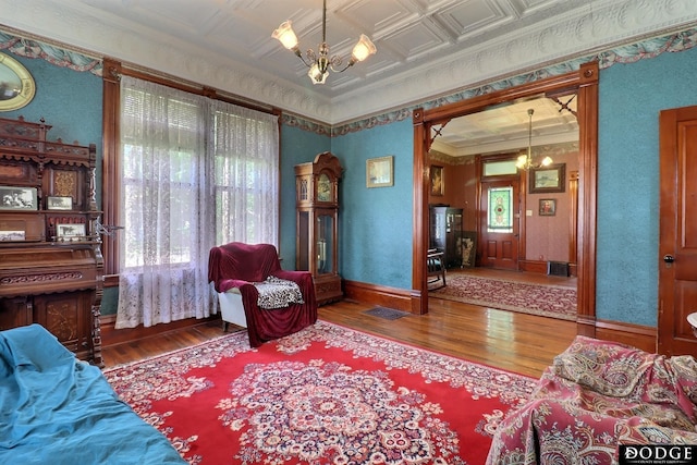 450 W 6th St, Fremont, NE 68025 - living area featuring a chandelier, wood finished floors, an ornate ceiling, and crown molding