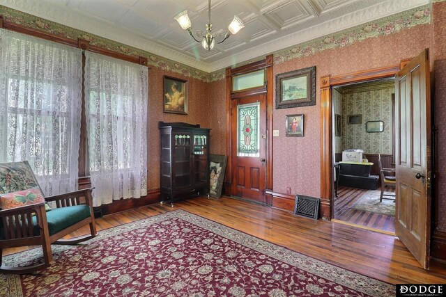 450 W 6th St, Fremont, NE 68025 - living area with wood-type flooring, wallpapered walls, a chandelier, and an ornate ceiling
