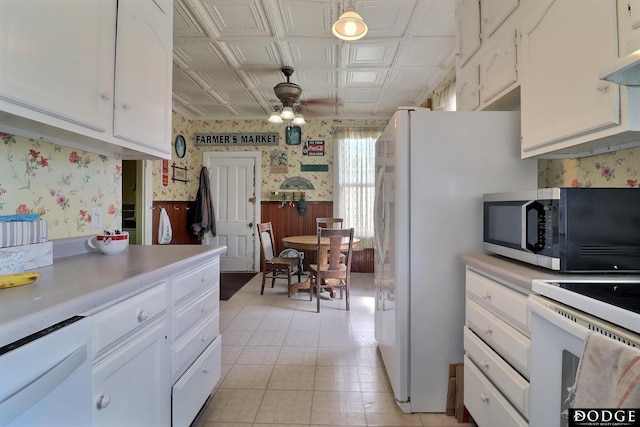 450 W 6th St, Fremont, NE 68025 - kitchen featuring wallpapered walls, white appliances, a ceiling fan, light countertops, and white cabinets