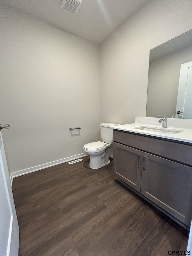 533 W Corsac Rd, Lincoln, NE 68523 - half bath with wood finished floors, toilet, vanity, and baseboards