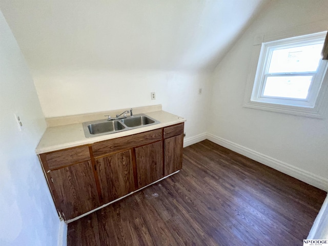 608 Mill St, Council Bluffs, IA 51503 - kitchen with a sink, lofted ceiling, dark wood finished floors, light countertops, and baseboards