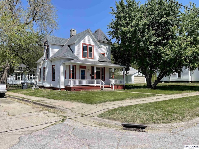 608 Mill St, Council Bluffs, IA 51503 - view of front of house featuring covered porch, a front lawn, a shingled roof, and a chimney