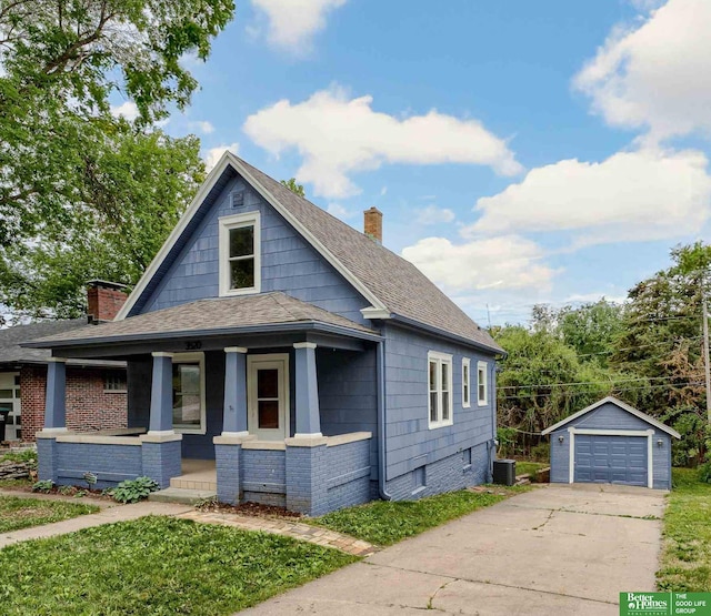 3520 N 55th St, Omaha, NE 68104 - bungalow-style house featuring a porch, a chimney, an outdoor structure, roof with shingles, and a garage