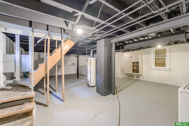 3520 N 55th St, Omaha, NE 68104 - unfinished below grade area featuring water heater, stairway, brick wall, and washer / dryer