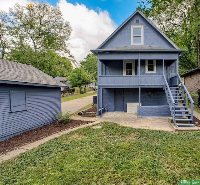 3520 N 55th St, Omaha, NE 68104 - back of property featuring stairway, a lawn, and a porch