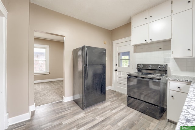 3520 N 55th St, Omaha, NE 68104 - kitchen with black appliances, light wood finished floors, and baseboards