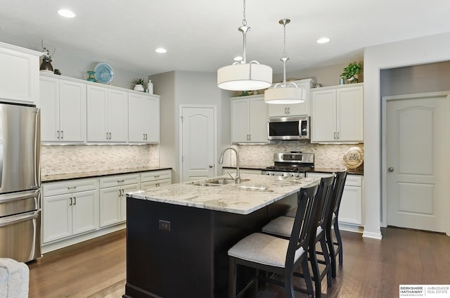 504 S 198th St, Elkhorn, NE 68022 - kitchen featuring appliances with stainless steel finishes, a sink, tasteful backsplash, dark wood-style floors, and recessed lighting