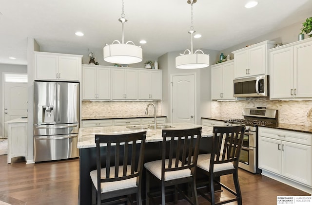 504 S 198th St, Elkhorn, NE 68022 - kitchen featuring appliances with stainless steel finishes, a sink, decorative backsplash, dark wood-type flooring, and recessed lighting