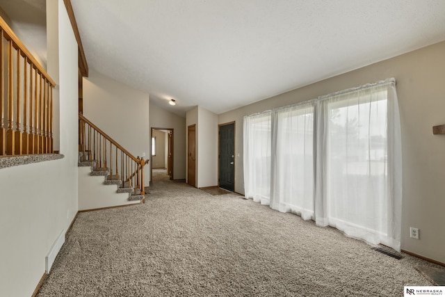 2211 Scarborough Dr, Bellevue, NE 68123 - unfurnished living room with carpet, stairs, baseboards, and lofted ceiling