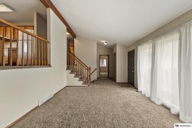 2211 Scarborough Dr, Bellevue, NE 68123 - entryway featuring stairway, carpet flooring, lofted ceiling, and baseboards